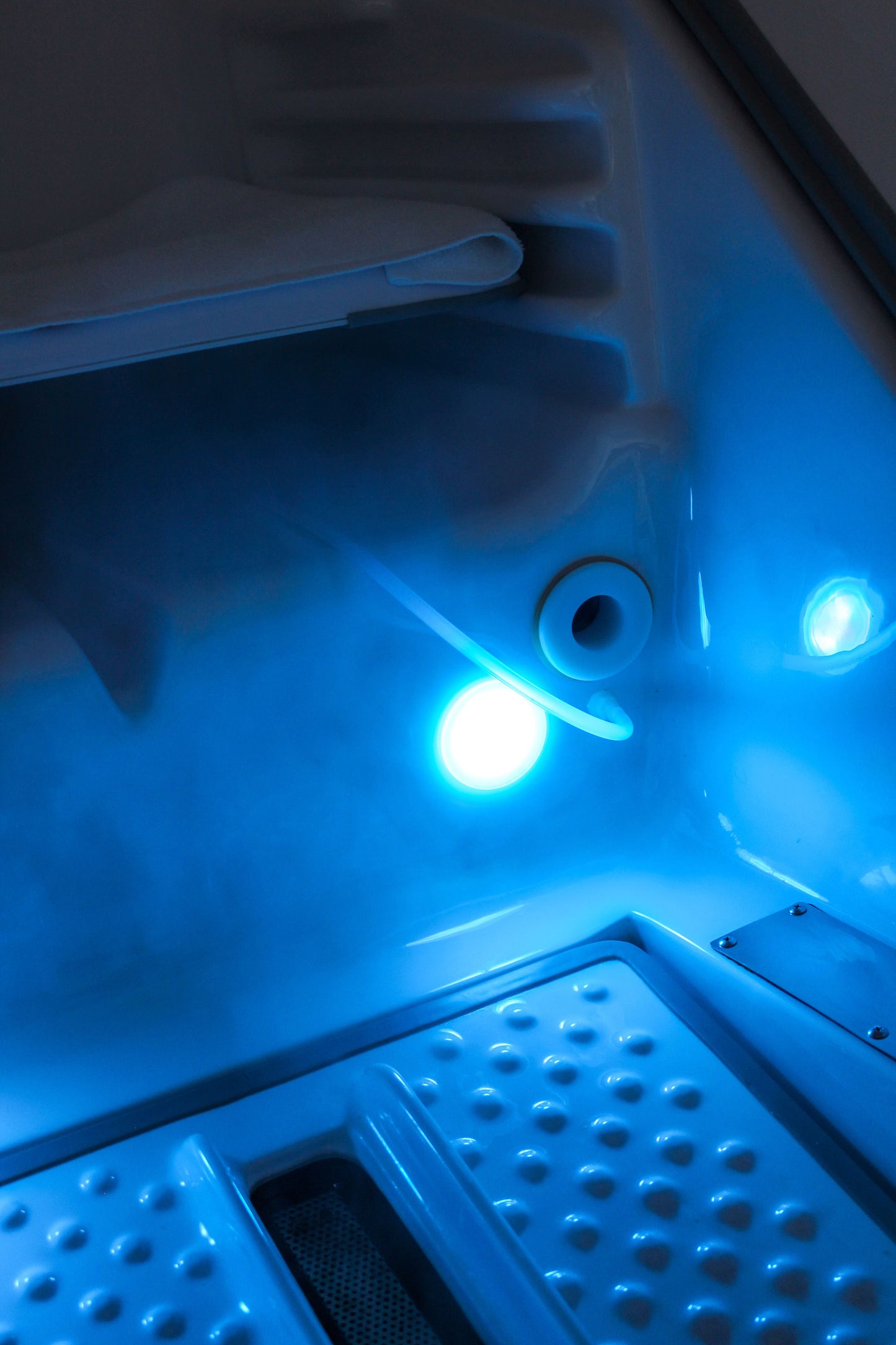 A close-up view of the glowing blue interior of a HOCATT sauna pod, visually representing the powerful Transdermal Ozone therapy used to boost energy and detoxify the body at Oceanbeach Oxygen.